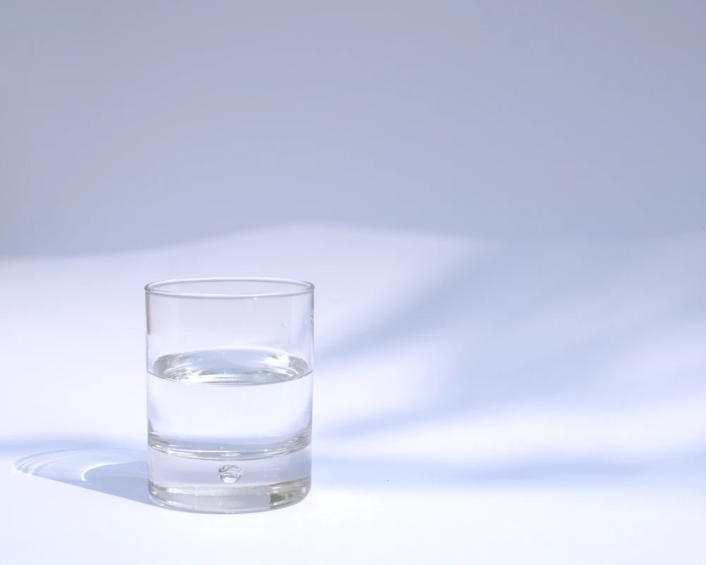 Glass of clean drinking water after RO filter replacement